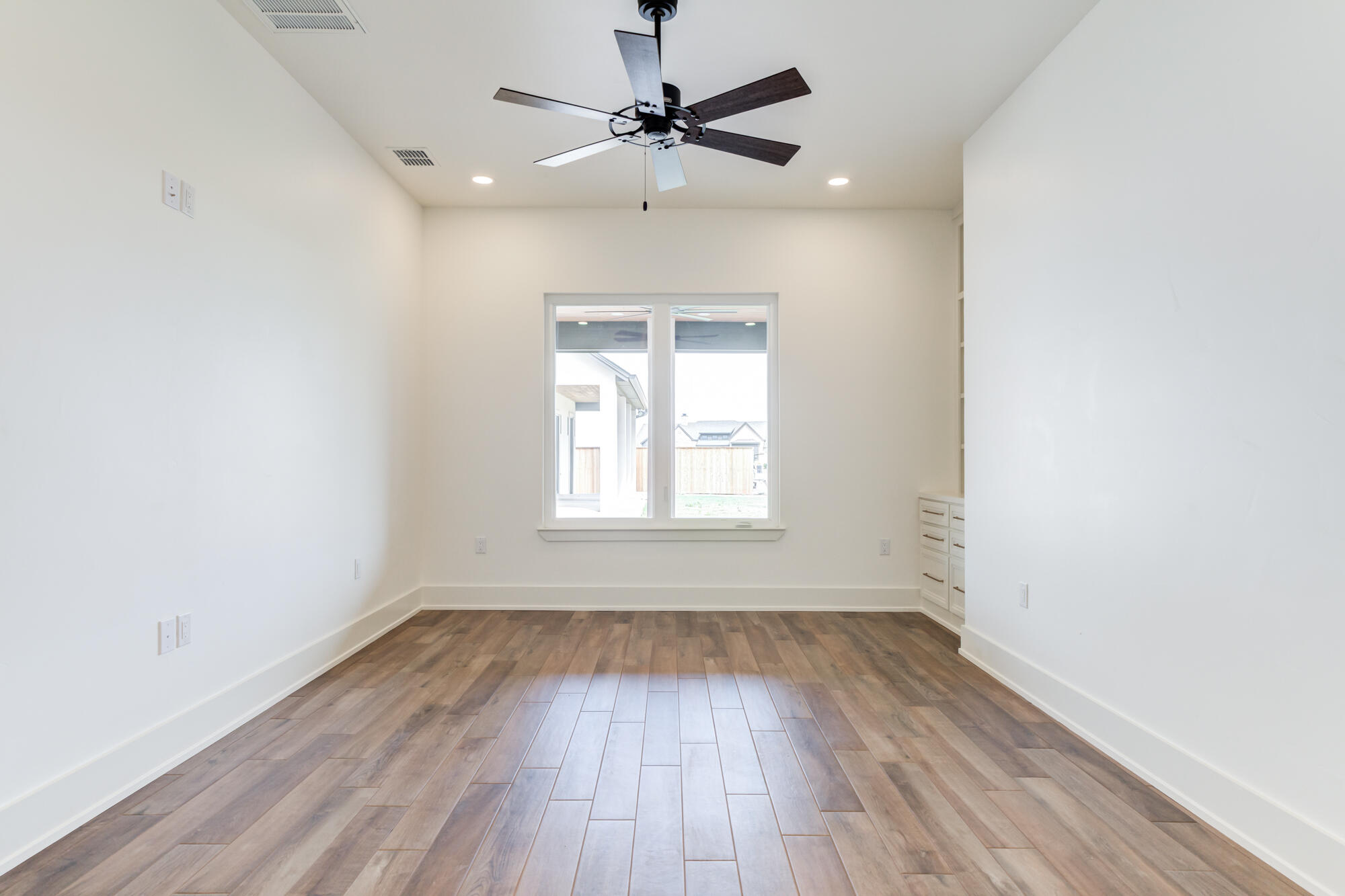 7710 46th Street Lubbock, TX 79407 - Photo 61 of 79 wooden floor in an empty room with a window