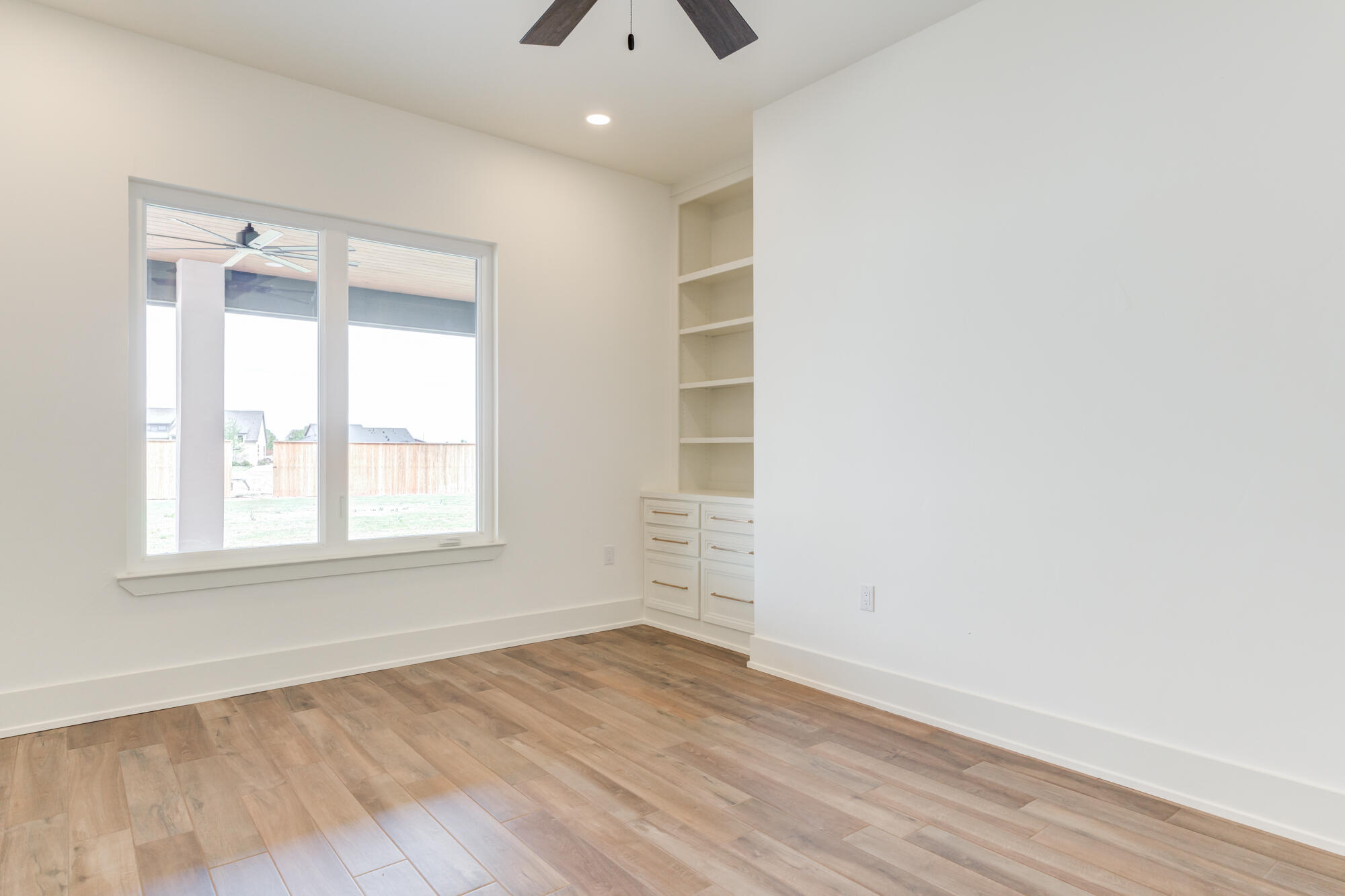 7710 46th Street Lubbock, TX 79407 - Photo 62 of 79 an empty room with wooden floor and windows