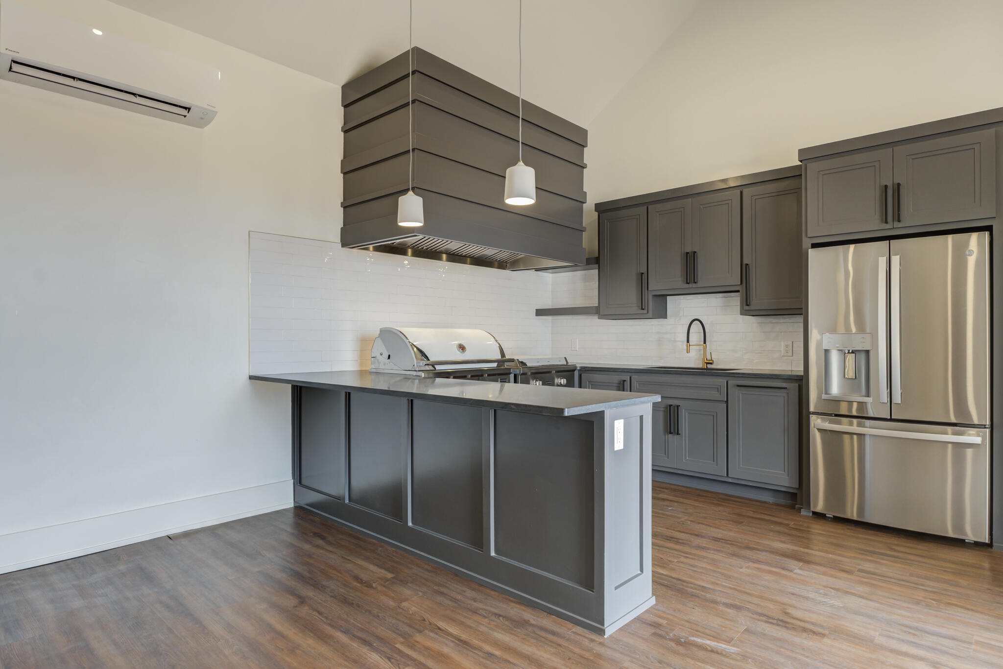 7710 46th Street Lubbock, TX 79407 - Photo 76 of 79 a kitchen with granite countertop stainless steel appliances a stove and wooden floor