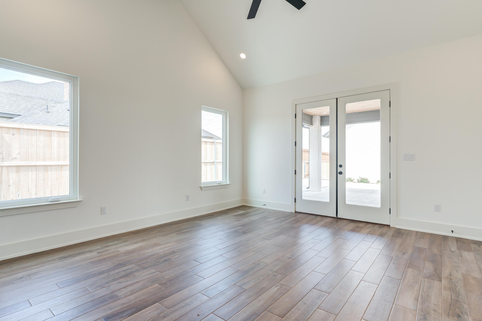 7710 46th Street Lubbock, TX 79407 - Photo 9 of 79 an empty room with wooden floor and windows