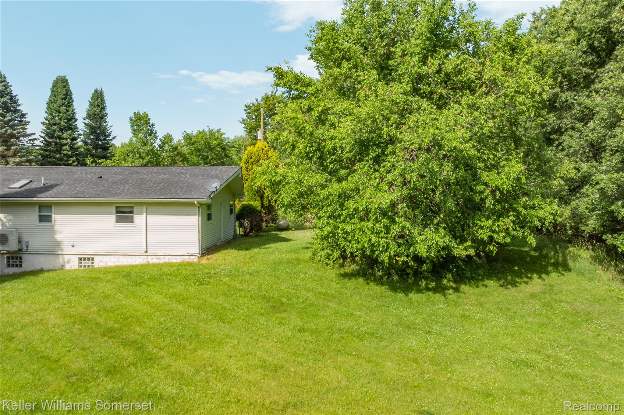 2344 Rochester Road Leonard, MI 48367 - Photo 60 of 66 Expansive green lawn bordering the property, framed by mature trees
