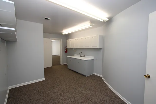 a view of a hallway to rooms