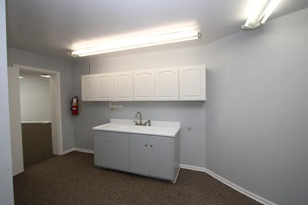 a bathroom with a sink a toilet and a window