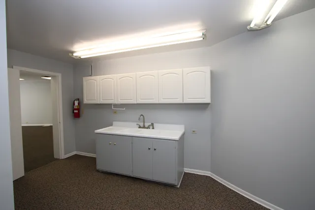 a bathroom with a sink a toilet and a window