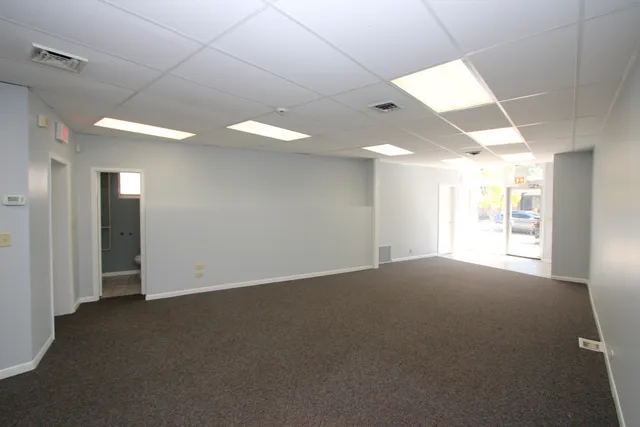 an empty room with windows and entrance