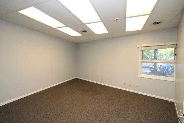 an empty room with a empty space and windows