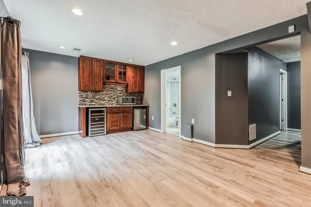 a view of a house with yard and wooden fence