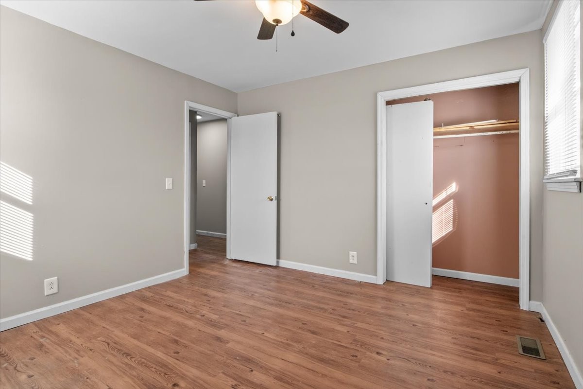 105 Mae Circle Dickson, TN 37055 - Photo 11 of 26 an empty room with wooden floor cabinet and windows
