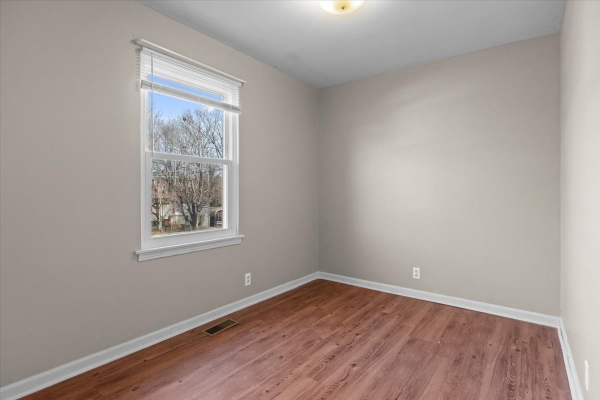 105 Mae Circle Dickson, TN 37055 - Photo 16 of 26 an empty room with wooden floor and windows