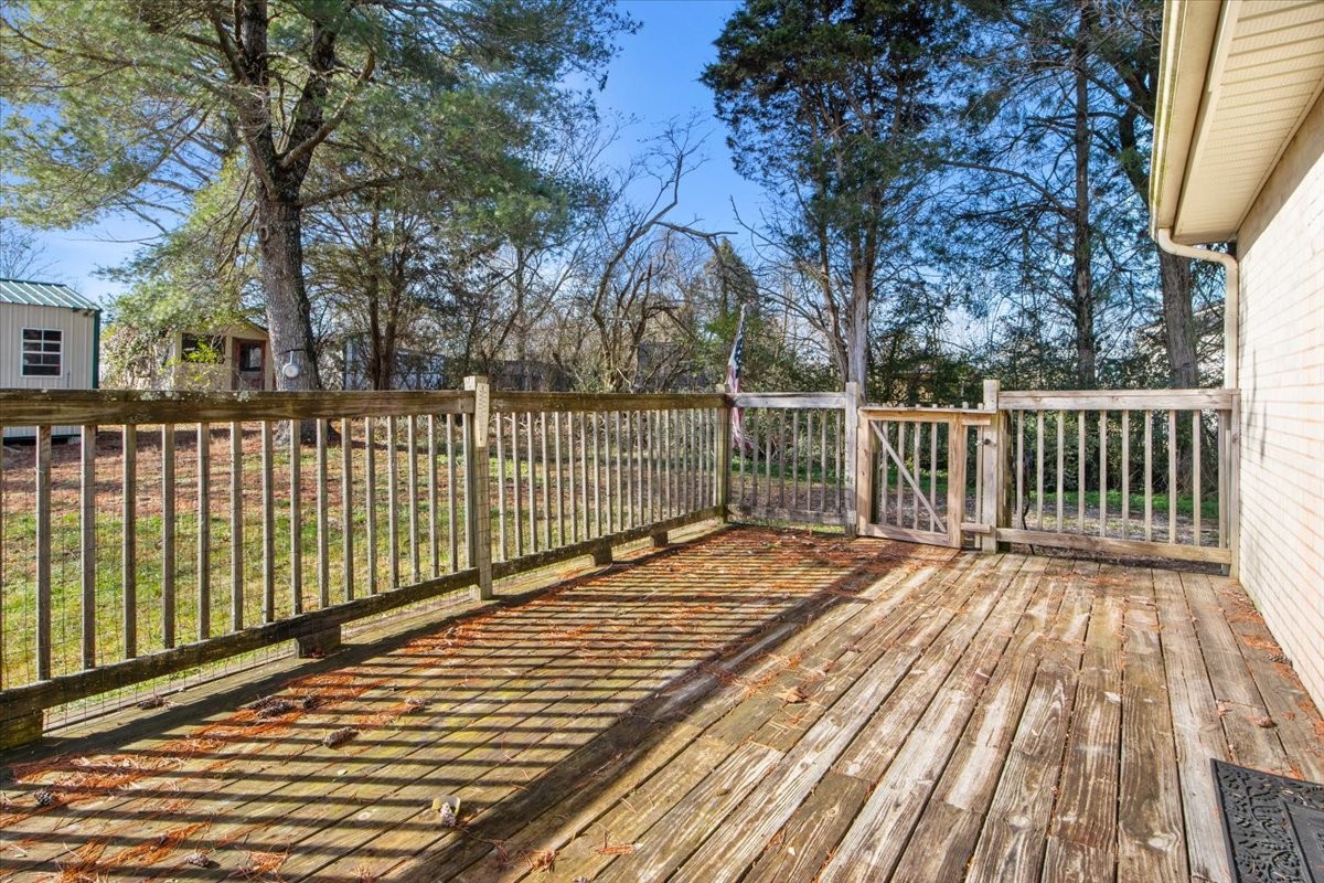 105 Mae Circle Dickson, TN 37055 - Photo 20 of 26 a view of deck with wooden floor and fence and trees