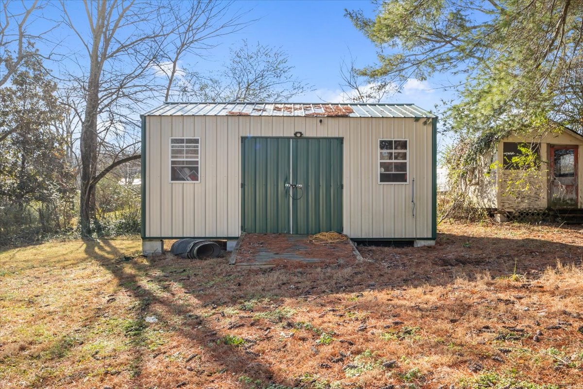 105 Mae Circle Dickson, TN 37055 - Photo 22 of 26 a view of a grey house with a large tree