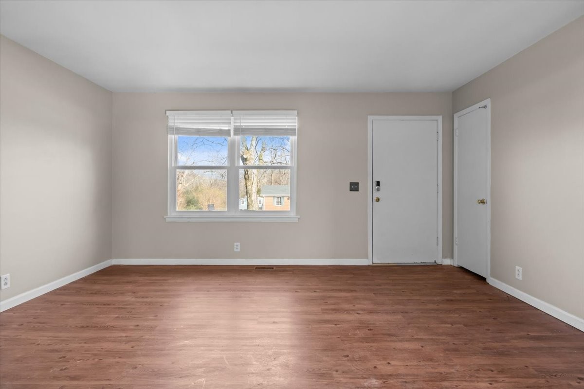 105 Mae Circle Dickson, TN 37055 - Photo 4 of 26 a view of an empty room with wooden floor and a window