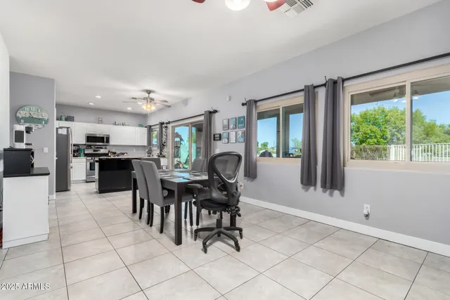 a view of a workspace with furniture and a window