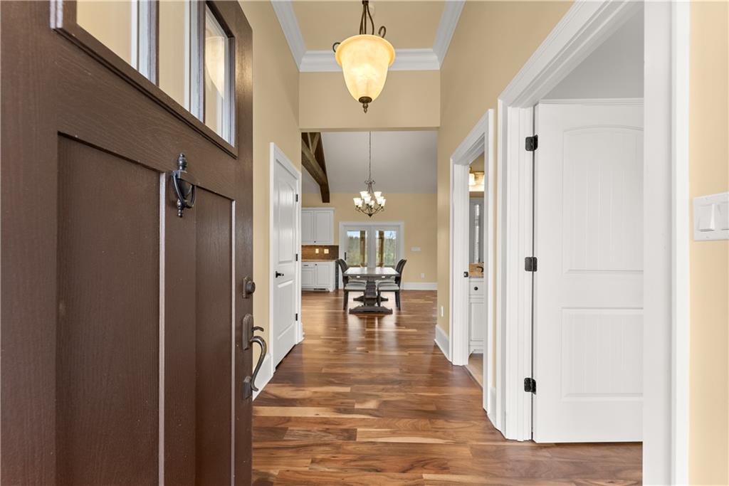 725 County Farm Road Jefferson, GA 30549 - Photo 6 of 66 a view of a hallway with wooden floor windows and chandelier