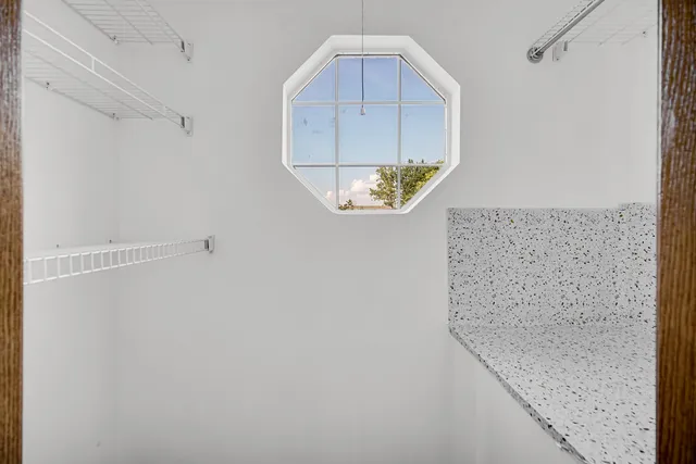 a bathroom with a granite countertop shower and a mirror