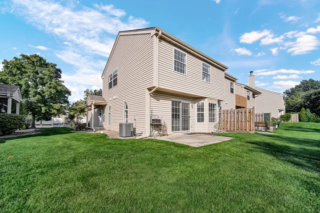 a front view of a house with a garden and trees
