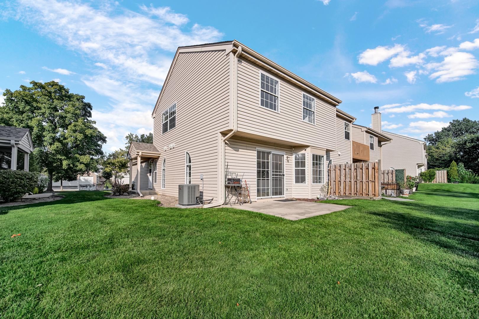 55 King Drive Streamwood, IL 60107 - Photo 16 of 18 a front view of a house with a garden and trees