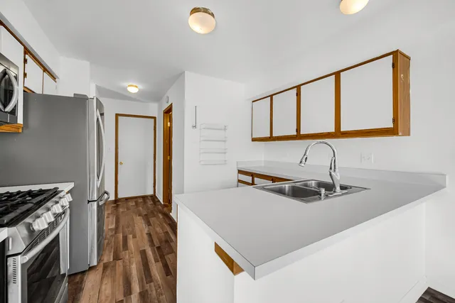 a kitchen with a sink a stove and a refrigerator