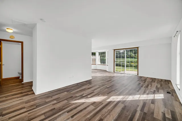 a view of a livingroom with wooden floor and windows