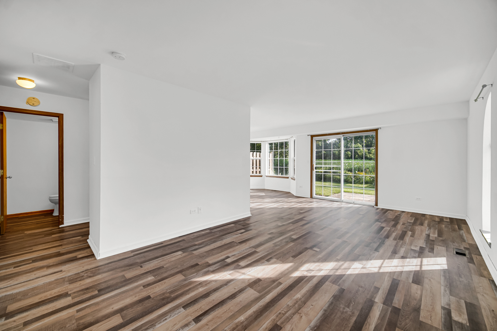 55 King Drive Streamwood, IL 60107 - Photo 7 of 18 a view of a livingroom with wooden floor and windows