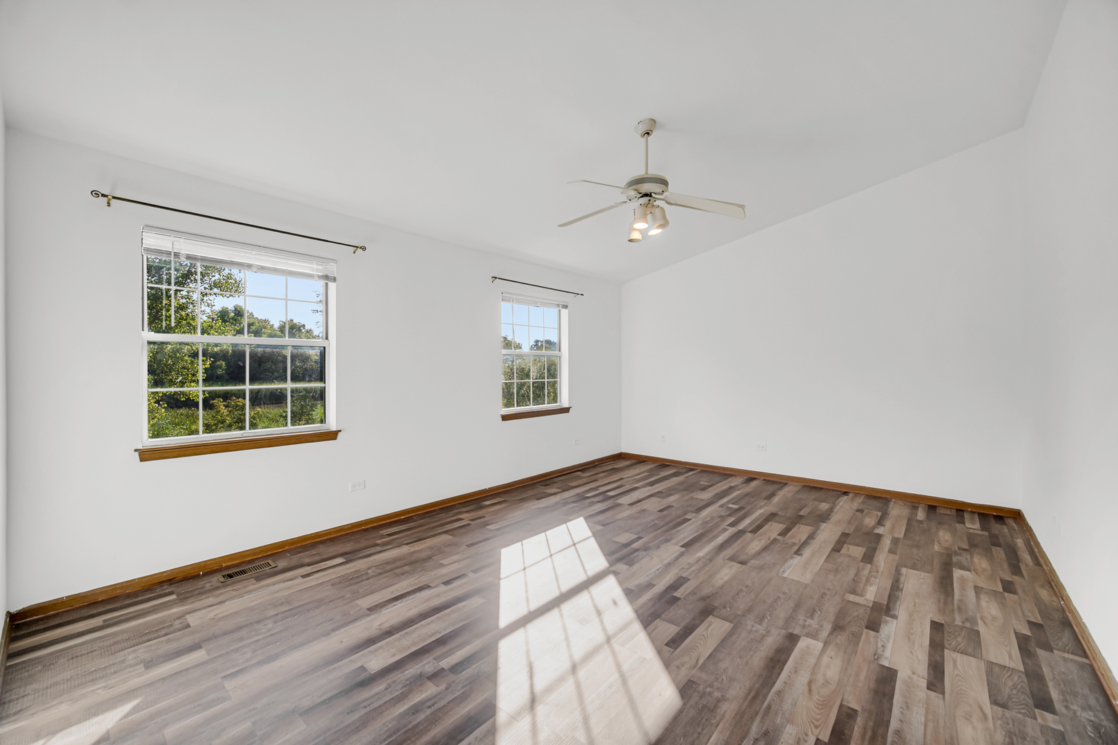 55 King Drive Streamwood, IL 60107 - Photo 8 of 18 a view of empty room with wooden floor and fan