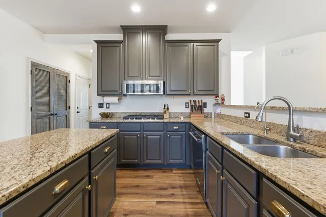 a kitchen with a sink stove and cabinets
