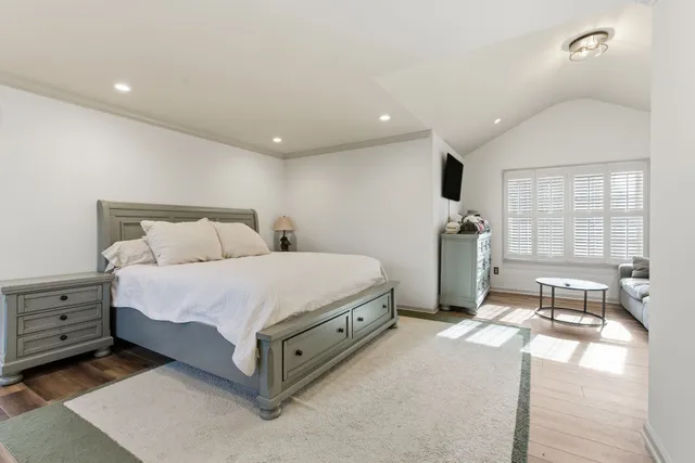 a spacious bedroom with a bed and a large window