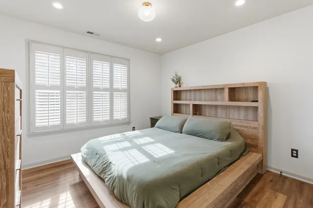 a bedroom with a large bed and a window