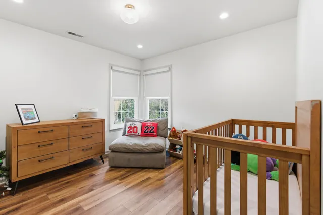 a bedroom with furniture and a baby crib