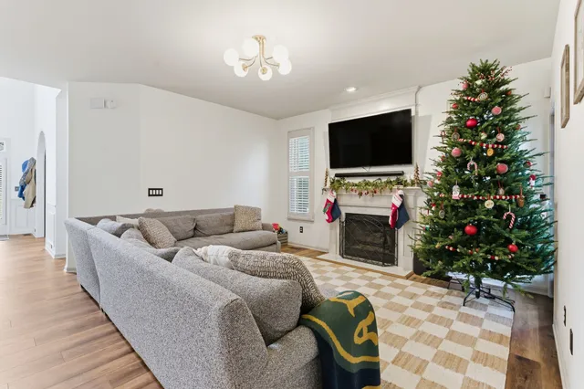 a living room with furniture a flat screen tv and a fireplace
