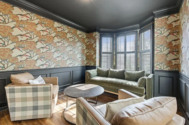 a living room with furniture and a floor to ceiling window