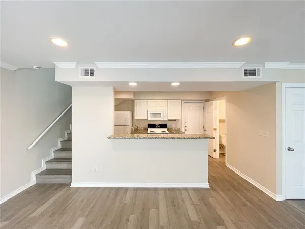 a kitchen with stainless steel appliances a refrigerator and a stove top oven
