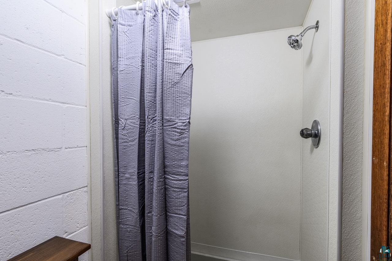2581 O'Rourke Road Hibbing, MN 55746 - Photo 28 of 61 White fiberglass shower enclosure with chrome fixtures