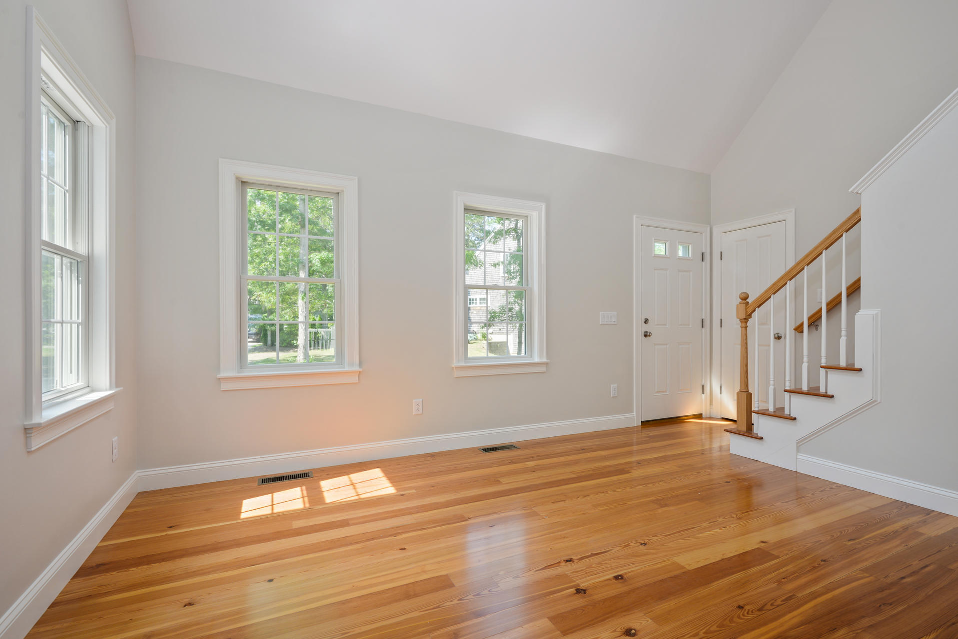 18 Asa Meiggs Road Sandwich, MA 02563 - Photo 3 of 30 a view of an empty room with wooden floor and a window