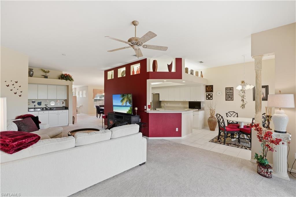 10871 Crooked River Road, Unit 202 Estero, FL 34135 - Photo 46 of 46 a living room with furniture a flat screen tv and a window