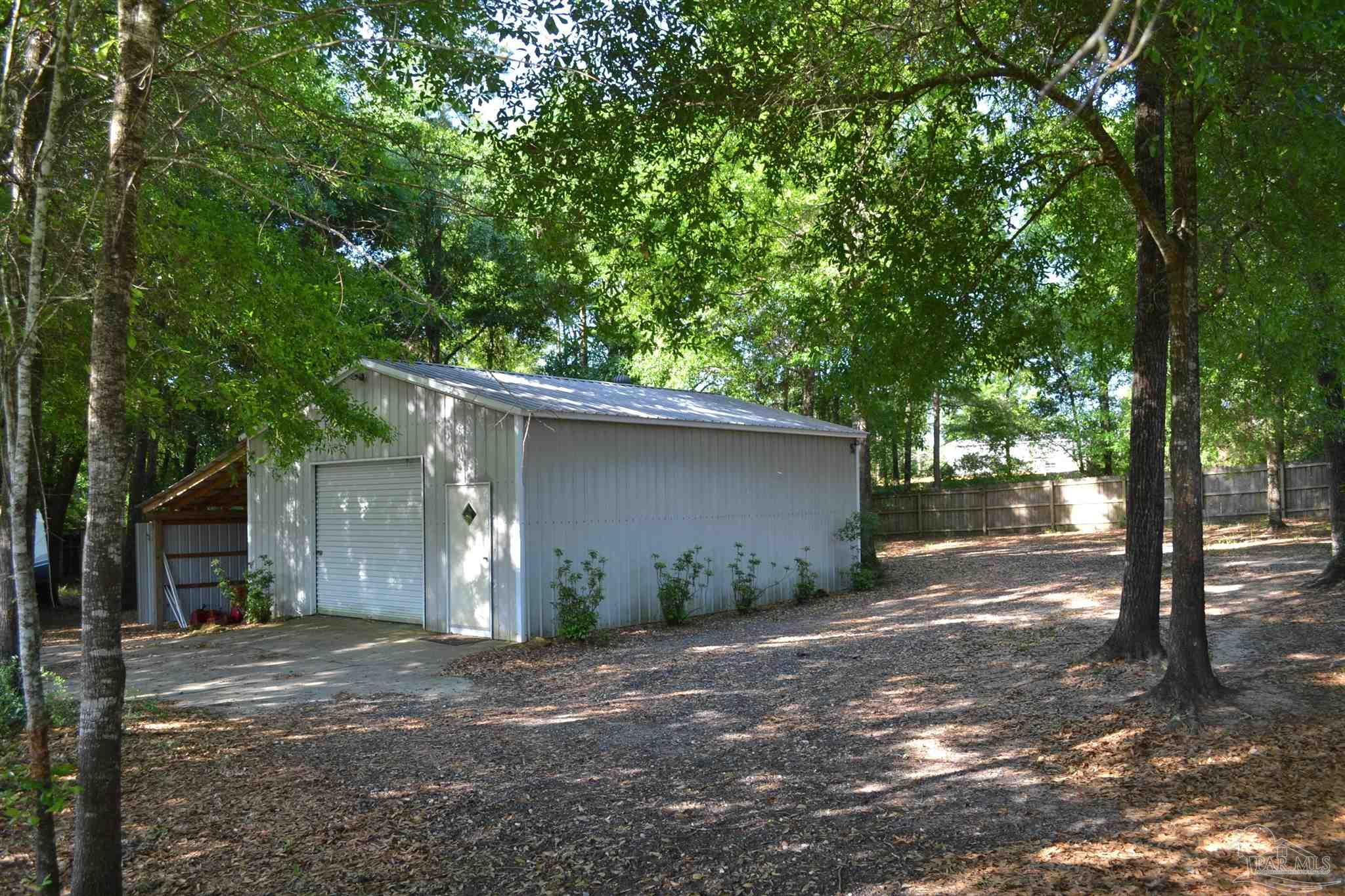 3055 Wallace Lake Road Pace, FL 32571 - Photo 11 of 33 a view of a back yard of the house