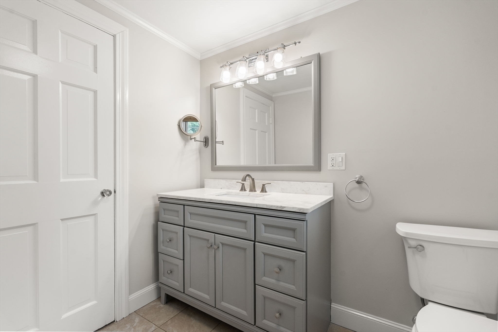 92 Abbot Street Andover, MA 01810 - Photo 22 of 35 a bathroom with a granite countertop sink a toilet and a mirror