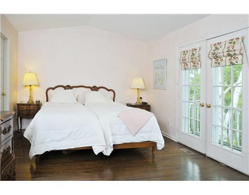 78 River Road, Unit 2 Cos Cob, CT 06807 - Photo 6 of 11 a bedroom with a bed and a night stand