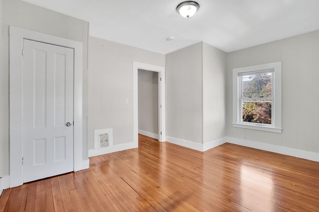 96 Bay Street Springfield, MA 01109 - Photo 25 of 25 an empty room with wooden floor and windows