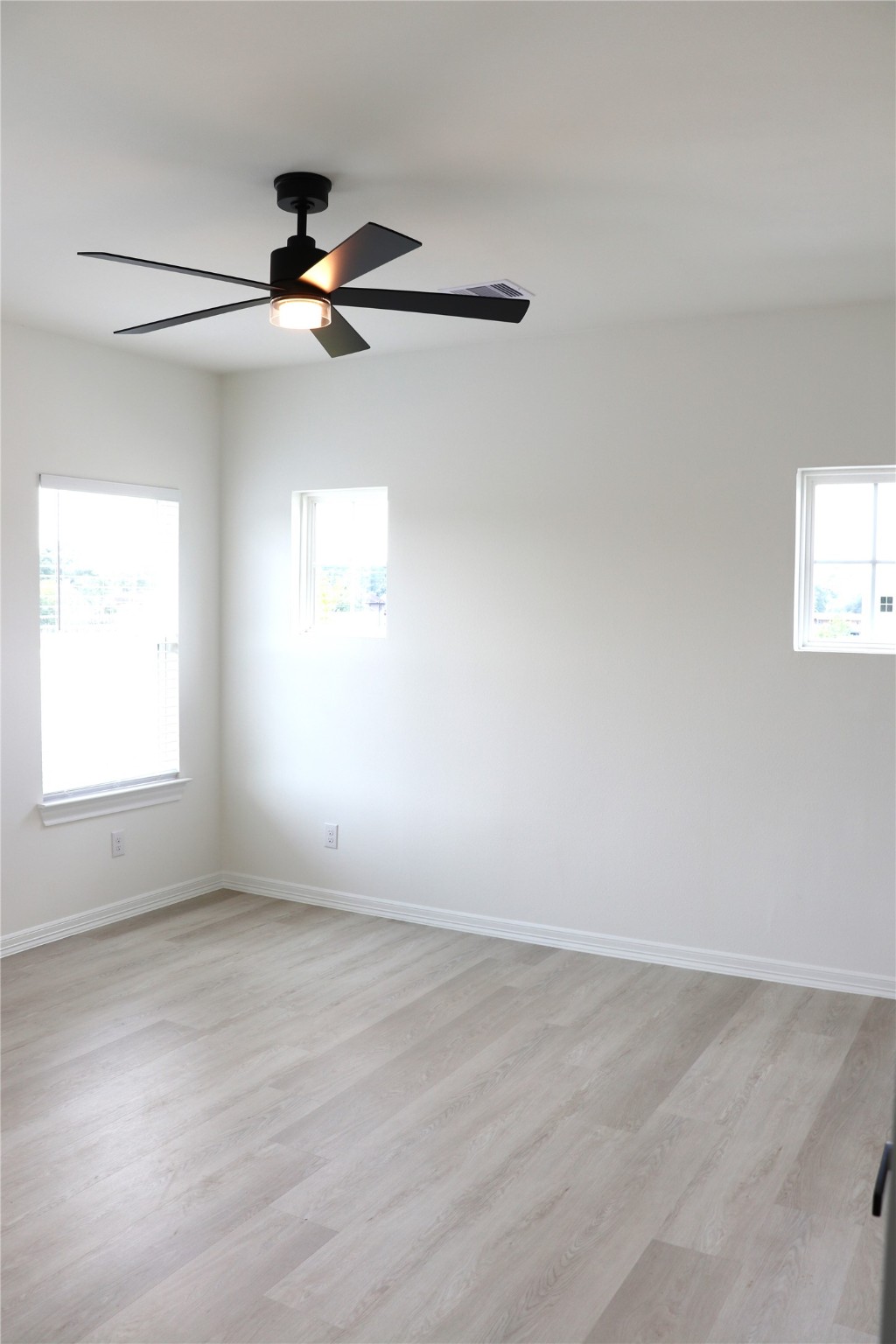 16602 Bonnie Sean Drive Spring, TX 77379 - Photo 13 of 14 an empty room with windows and fan