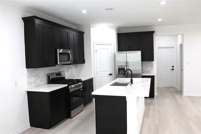 a kitchen with a sink stove and refrigerator