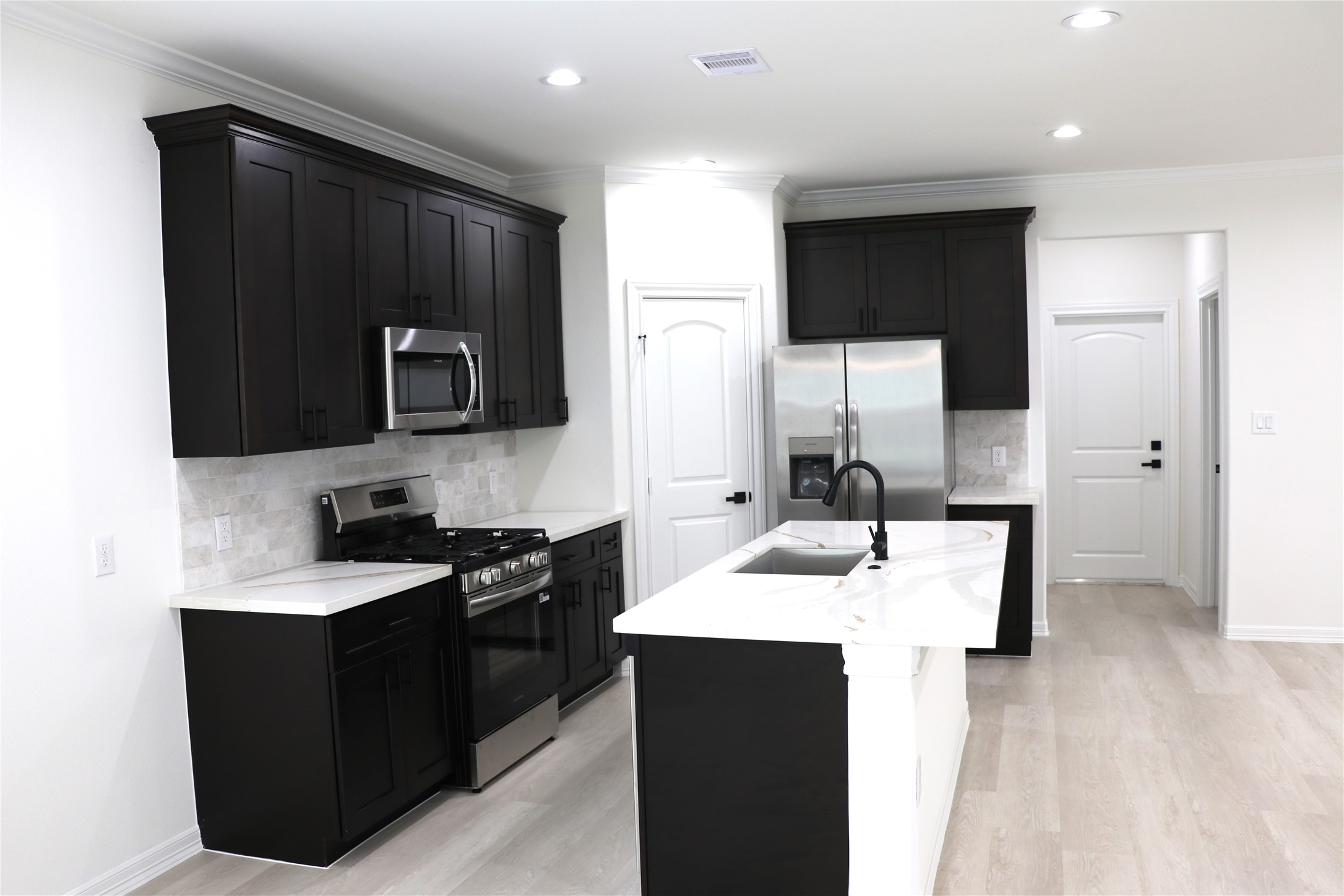 16602 Bonnie Sean Drive Spring, TX 77379 - Photo 3 of 14 a kitchen with a sink stove and refrigerator