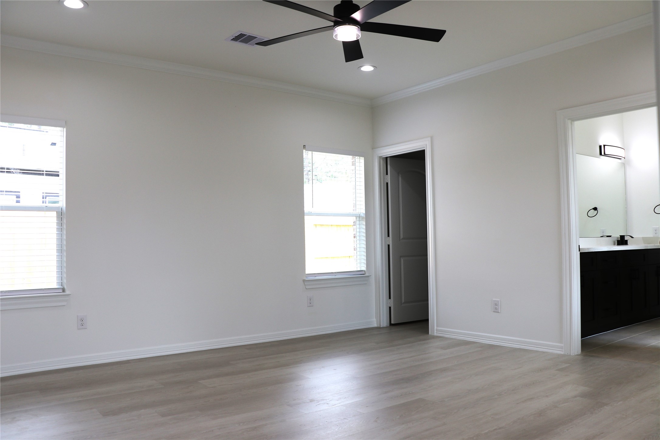 16602 Bonnie Sean Drive Spring, TX 77379 - Photo 6 of 14 an empty room with wooden floor ceiling fan and windows