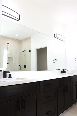 a bathroom with a double vanity sink and mirror