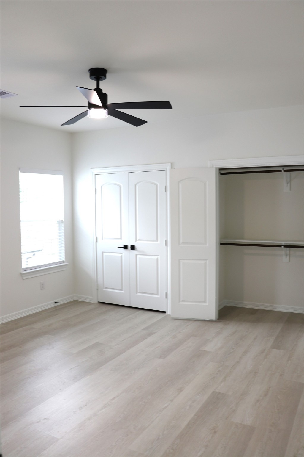 16602 Bonnie Sean Drive Spring, TX 77379 - Photo 10 of 14 an empty room with windows and fan