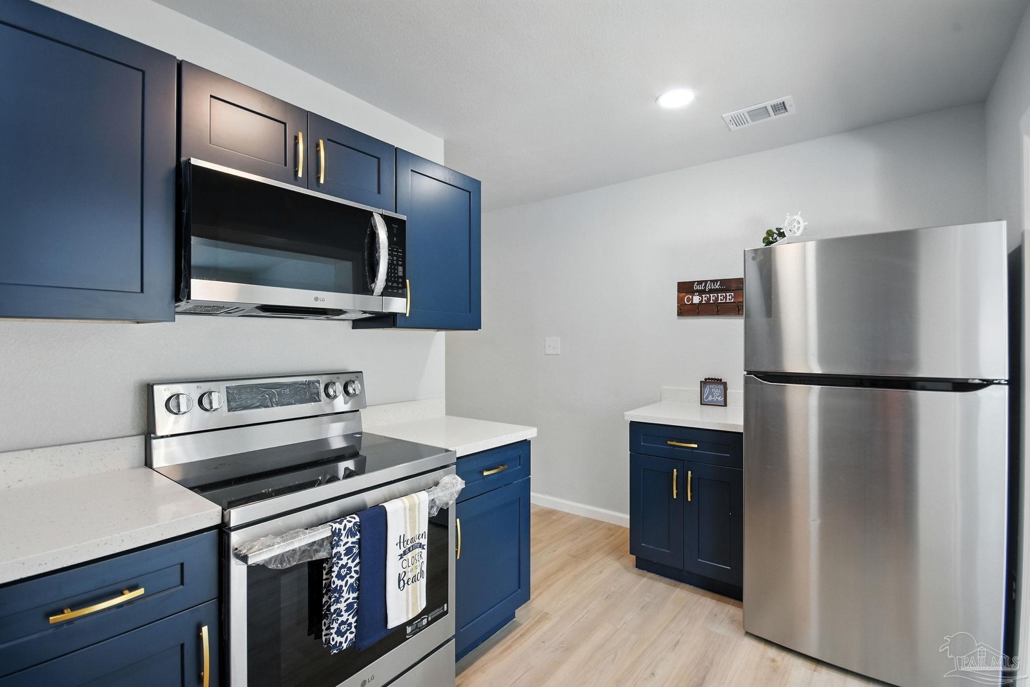 609 Pelham Road Pensacola, FL 32507 - Photo 8 of 27 a kitchen with a refrigerator stove and microwave