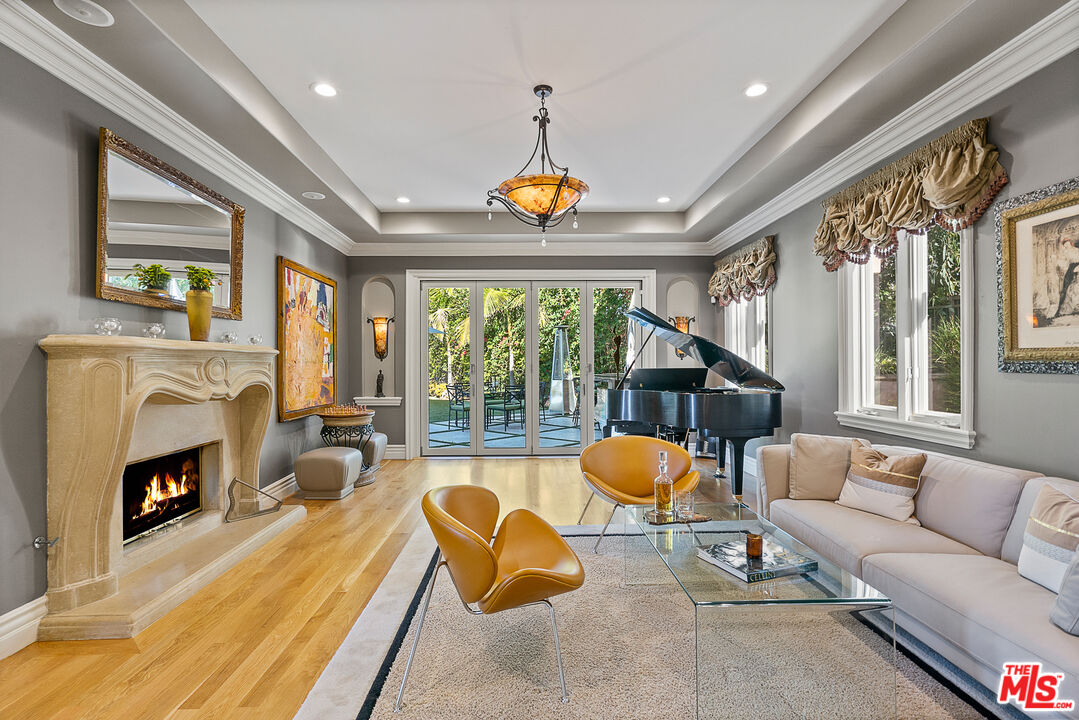 1861 Bel Air Road Los Angeles, CA 90077 - Photo 12 of 44 a living room with furniture fireplace and a large window
