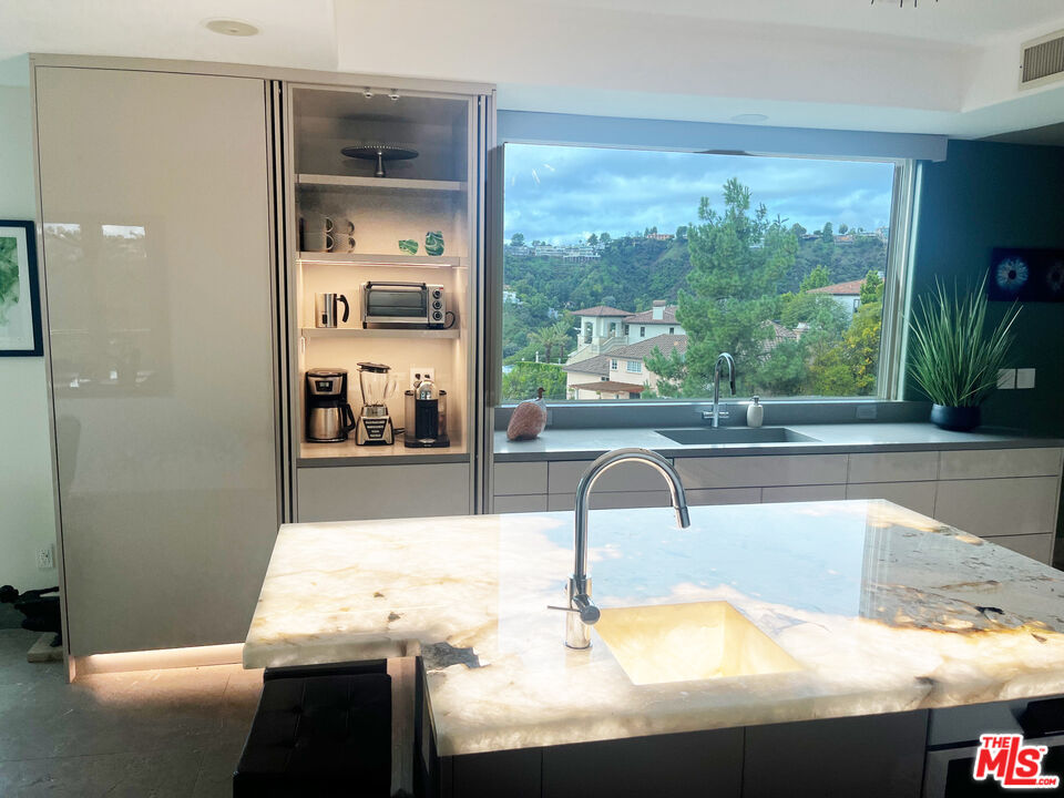 1861 Bel Air Road Los Angeles, CA 90077 - Photo 15 of 44 a kitchen with a sink and a large window