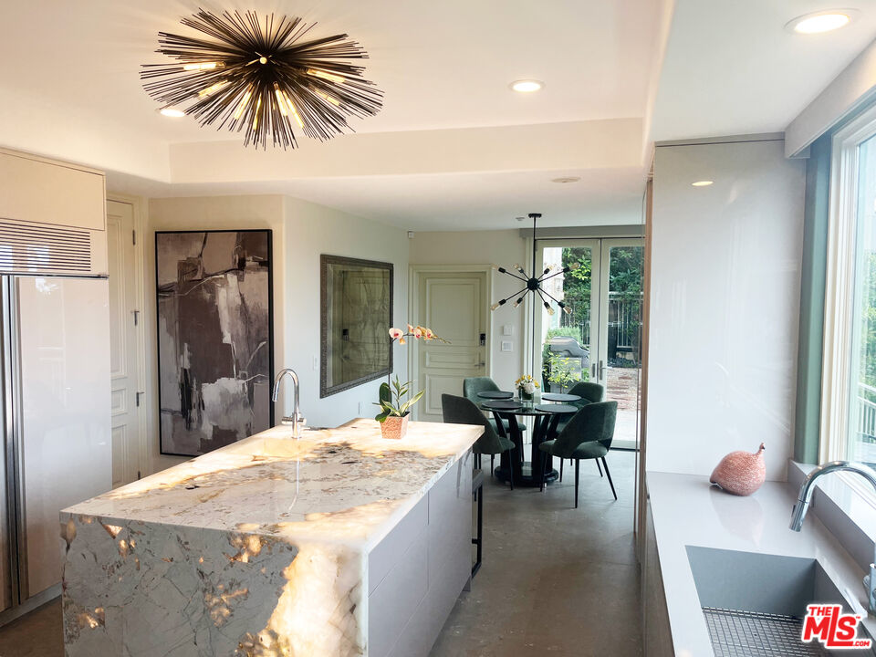 1861 Bel Air Road Los Angeles, CA 90077 - Photo 17 of 44 a dining hall with a dining table and chairs