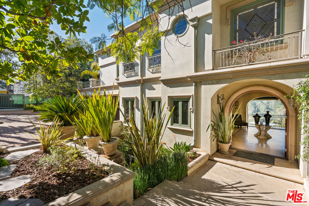 1861 Bel Air Road Los Angeles, CA 90077 - Photo 24 of 44 a front view of a house with a yard